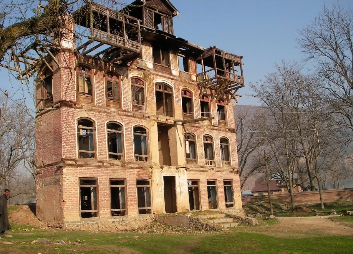 The house stripped of its doors, frames, and latticework